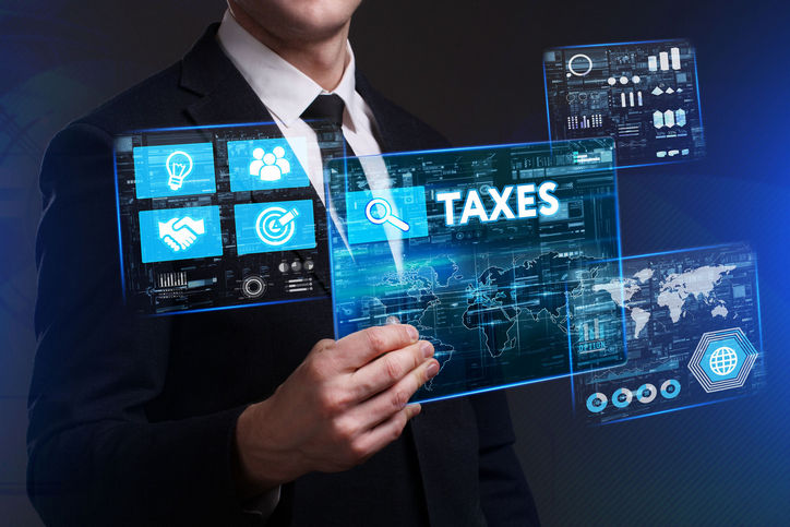 75750020 - business, technology, internet and network concept. young businessman working on a virtual screen of the future and sees the inscription: taxes