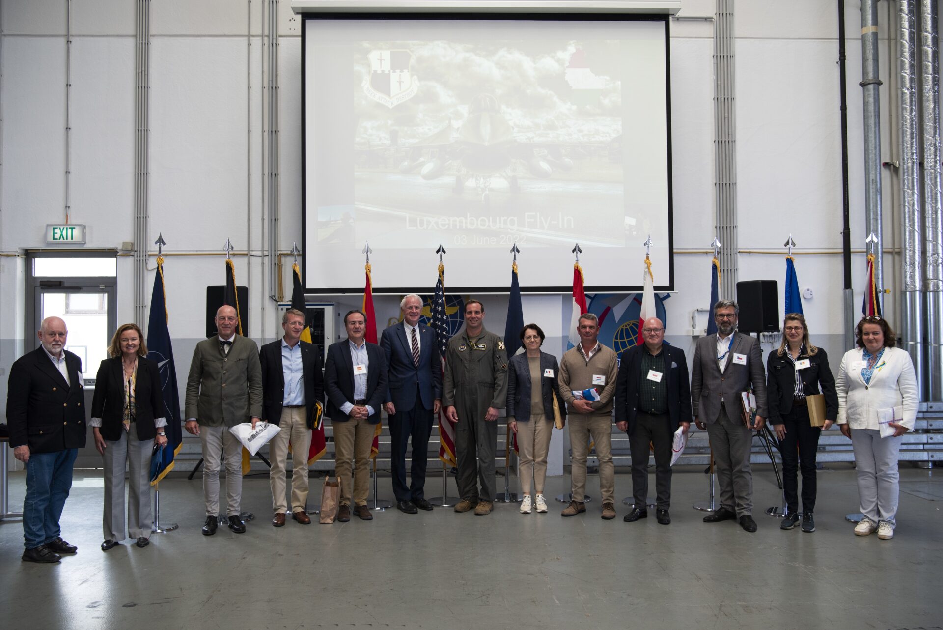Col. Leslie Hauck, center, 52nd Fighter Wing commander, poses with visitors, including multiple ambassadors from NATO countries at Spangdahlem Air Base, Germany, June 3, 2022. NATO promotes democratic values and diplomacy; and enables members to consult and cooperate on defense and security-related issues, to build trust and, ultimately, to prevent conflict.